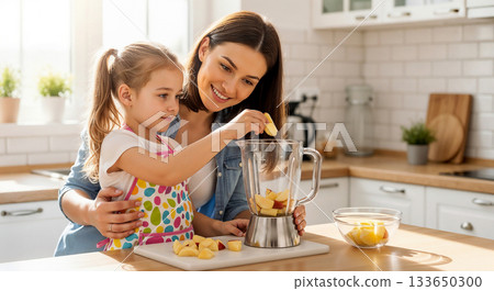 A mother and daughter are making a fruit smoothie together using a blender. 133650300