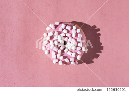 Pink frosted donut with marshmallow toppings on pastel pink background 133650601