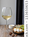 Elegant wine and cheese board with grapes and nuts on rustic wooden table 133650653
