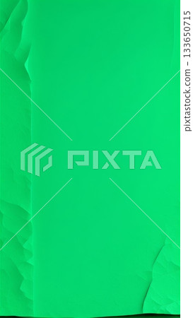 Green textured paper with wrinkled edges on solid background. Minimal abstract template with copy space for design and layout. 133650715
