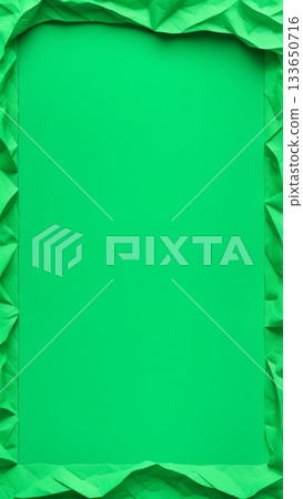 Crumpled green paper frame with empty center on solid background. Abstract textured border with copy space for design and layout. 133650716