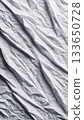 Abstract white grey crumpled paper texture with diagonal geometric folds, modern polygonal background perfect for design and visual projects. 133650728