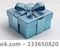 Seasonal decor. Blue box wrapped with a bow on white background. Jewelry, birthdays, Christmas and luxury branding. 133650820