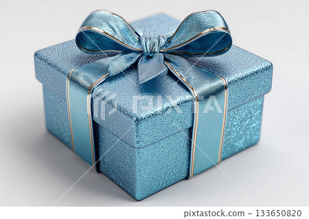Seasonal decor. Blue box wrapped with a bow on white background. Jewelry, birthdays, Christmas and luxury branding. Seasonal decor. Blue box wrapped with a bow on white background. Jewelry, birthdays, Christmas and luxury branding. 133650820