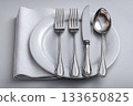 Minimalist design. Full silverware set. Including soup spoon, dinner fork, knife, dessert fork and teaspoon, perfectly arranged on a white background. Formal dining setting. 133650825