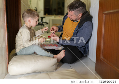 Father and son bonding sharing creative hobby moment Father and son bonding sharing creative hobby moment 133650954