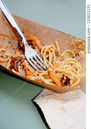 leftovers of two pasta dishes on a green table leftovers of two pasta dishes on a green table 133651151