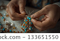 Close-up of Artisan Crafting Jewelry with Beads and Wires 133651550