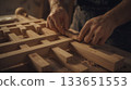 Close-up of Skilled Hands Assembling Wooden Furniture in Workshop 133651553