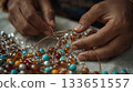 Close-up of Artisan Crafting Jewelry with Beads and Wires 133651557