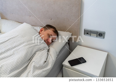 Middle aged man resting in a bed 133651651