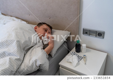 Man has fever and common cold Man has fever and common cold 133651654