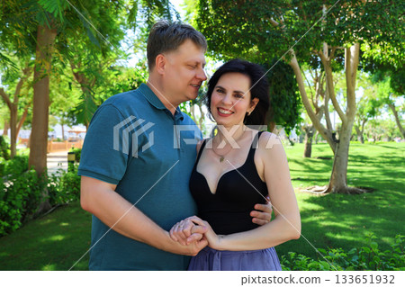A forty-year-old husband and wife pose for a family photo album 133651932