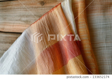 Luxurious Silk Textile Drape Folds in Subdued Earthy Tones for Elegant Background Design Luxurious Silk Textile Drape Folds in Subdued Earthy Tones for Elegant Background Design 133652174