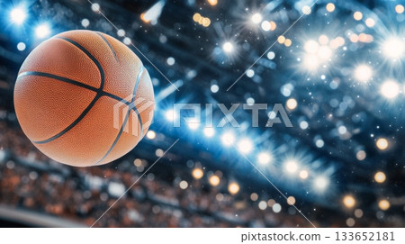 Dynamic Basketball Action Shot Orange Ball in Motion with Blurred Arena Crowd in Background 133652181