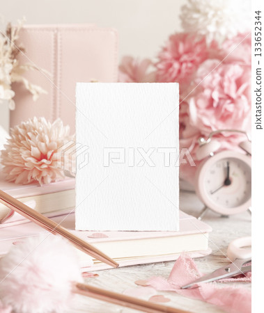 Vertical blank card near romantic pink decor, hearts and flowers closeup, Valentines spring mockup Vertical blank card near romantic pink decor, hearts and flowers closeup, Valentines spring mockup 133652344