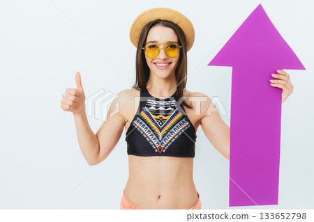 Woman is holding a purple paper with an arrow pointing upwards 133652798