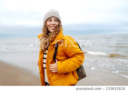 Attractive woman on a windy cold beach. Travel, nature concept. Attractive woman on a windy cold beach. Travel, nature concept. 133652818