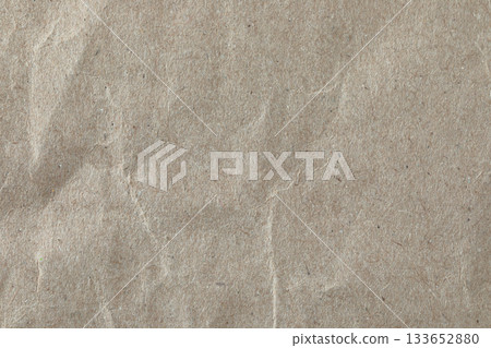 Crumpled kraft paper texture, macro close-up. Ideal as a natural background or design element for eco and craft-themed projects Crumpled kraft paper texture, macro close-up. Ideal as a natural background or design element for eco and craft-themed projects 133652880