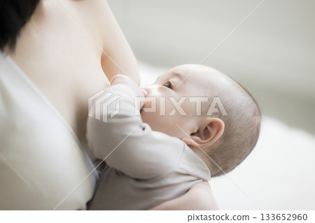 Mother giving milk to her baby 133652960