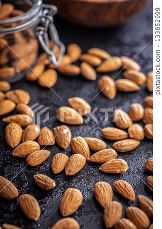 Almond kernel nuts on black table. 133652999