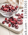 Tasty dried cranberries on white table. 133653003