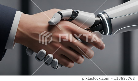 Close-up handshake between a human and a futuristic robot, symbolizing cooperation between people and artificial intelligence. Close-up handshake between a human and a futuristic robot, symbolizing cooperation between people and artificial intelligence. 133653768