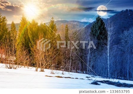 mountain landscape with mixed forest on snow covered slope. day and night time change concept. sky with clouds, sun and moon on spring equinox. duality and transition template. naked trees scenery mountain landscape with mixed forest on snow covered slope. day and night time change concept. sky with clouds, sun and moon on spring equinox. duality and transition template. naked trees scenery 133653795