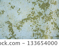 Peeling painted concrete wall, cracks of green blue and beige, peeling paint of the old rough concrete wall, peeling paint texture 133654000