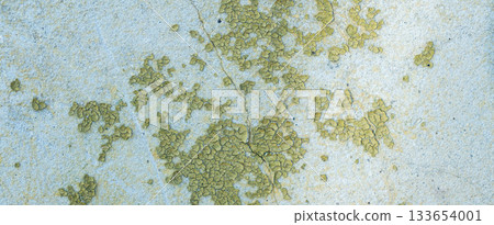 Peeling painted concrete wall, cracks of green blue and beige, peeling paint of the old rough concrete wall, peeling paint texture 133654001