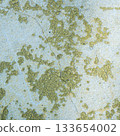 Peeling painted concrete wall, cracks of green blue and beige, peeling paint of the old rough concrete wall, peeling paint texture 133654002
