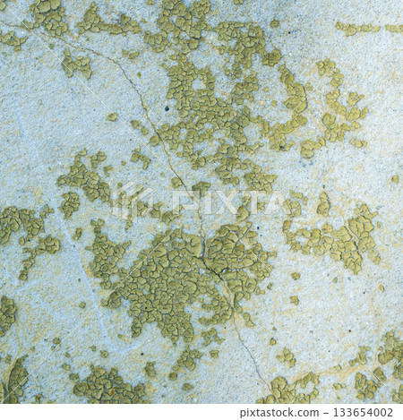 Peeling painted concrete wall, cracks of green blue and beige, peeling paint of the old rough concrete wall, peeling paint texture 133654002