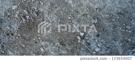 Close-up of a gray-black lava texture on the ground. Porous, cracked, and stony, perfect as a stock texture or photo background. Impression of molten rock. Close-up of a gray-black lava texture on the ground. Porous, cracked, and stony, perfect as a stock texture or photo background. Impression of molten rock. 133654007