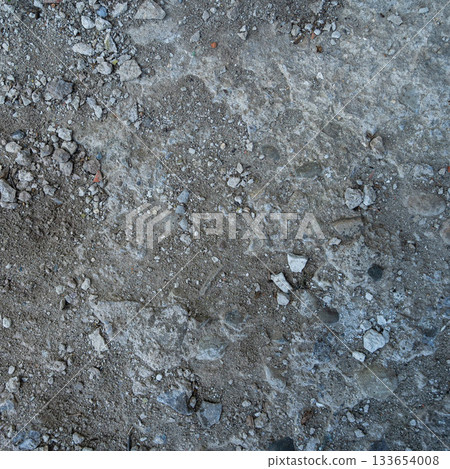 Close-up of a gray-black lava texture on the ground. Porous, cracked, and stony, perfect as a stock texture or photo background. Impression of molten rock. 133654008