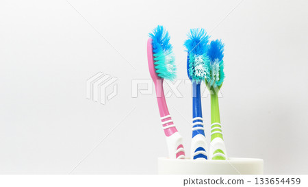 Old Worn Toothbrushes in Cup for Dental Hygiene Concepts Old Worn Toothbrushes in Cup for Dental Hygiene Concepts 133654459
