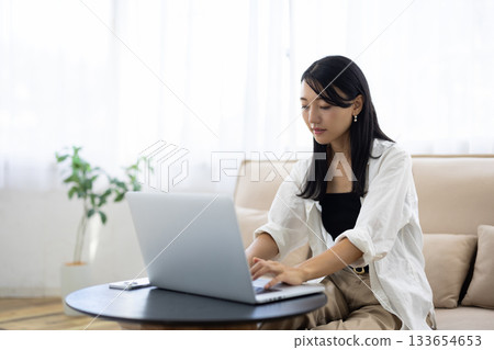 Young woman working on personal computer Young woman working on personal computer 133654653