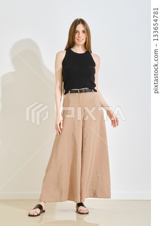 Trendy female outfit featuring wide-legged pants and a sleeveless top for casual outings 133654781