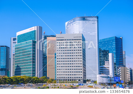Tokyo cityscape in Japan: View of the Shiodome buildings and the former Tsukiji Market (6) including the temporary access road and removal of the upper structure of the loading pier 133654876