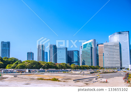 Tokyo cityscape in Japan: View of the Shiodome buildings and the former Tsukiji Market (6) including the temporary access road and removal of the upper structure of the loading pier 133655102