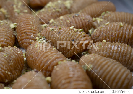 Lebanese recipe for Maakaroun fritters: fine wheat semolina, flour, butter, oil, ground anise 133655664