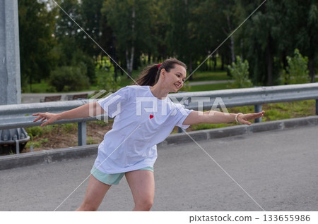 Caucasian woman in shorts roller skating.  133655986