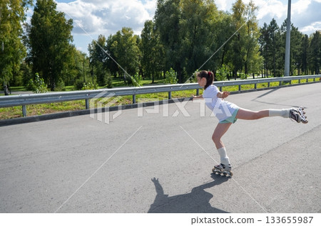 Caucasian woman in shorts roller skating. Caucasian woman in shorts roller skating. 133655987