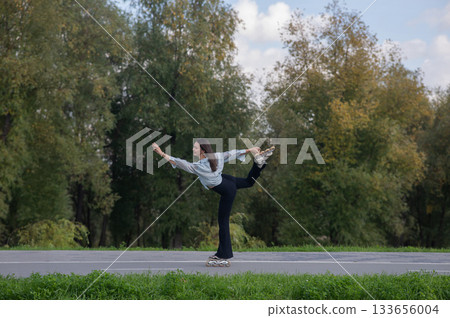 Caucasian woman roller skating in park.  133656004