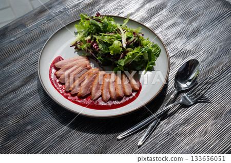 Roasted duck cut into pieces on a plate. Roasted duck cut into pieces on a plate. 133656051