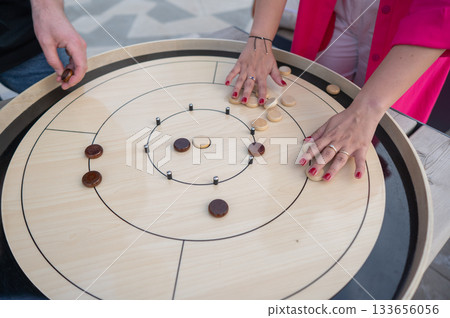 Strategic Game Pieces on a Wooden Board crokinole.  133656056