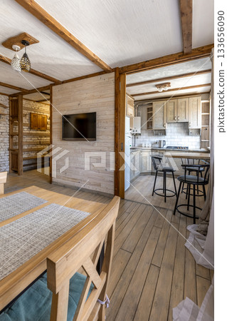 Bright Rustic Living Room and Kitchen Interior with Wooden Furniture Bright Rustic Living Room and Kitchen Interior with Wooden Furniture 133656090