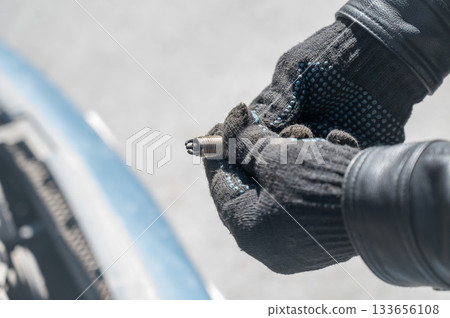 Caucasian man changing spark plugs in car.  133656108