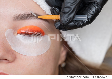 Caucasian woman undergoing eyelash lamination procedure.  133656243