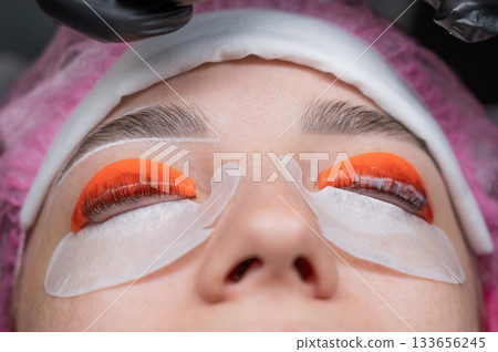 Caucasian woman undergoing eyelash lamination procedure. Caucasian woman undergoing eyelash lamination procedure. 133656245