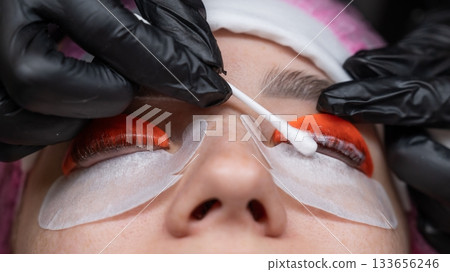 Caucasian woman undergoing eyelash lamination procedure. Caucasian woman undergoing eyelash lamination procedure. 133656246